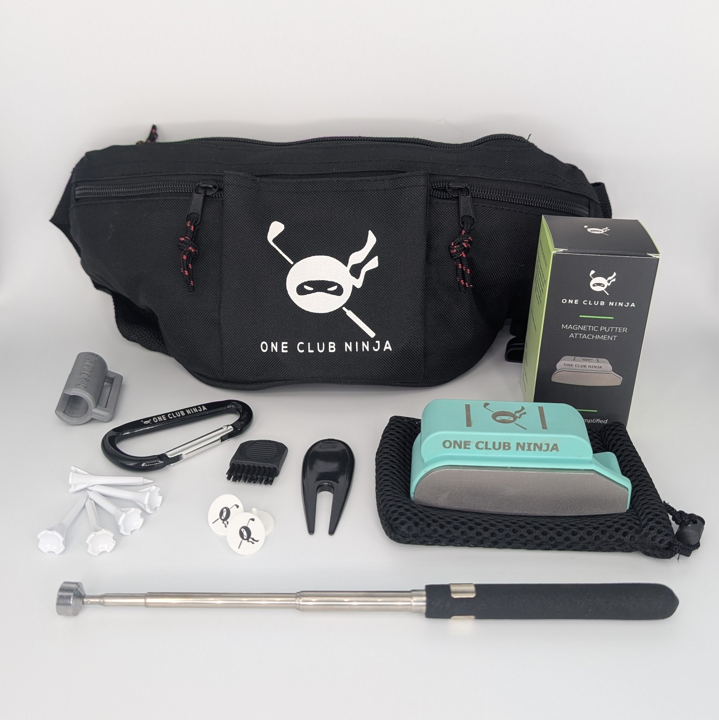 The One Club Kit flat lay with the Green putter attachment, waist bag, telescoping alignment stick, and accessories