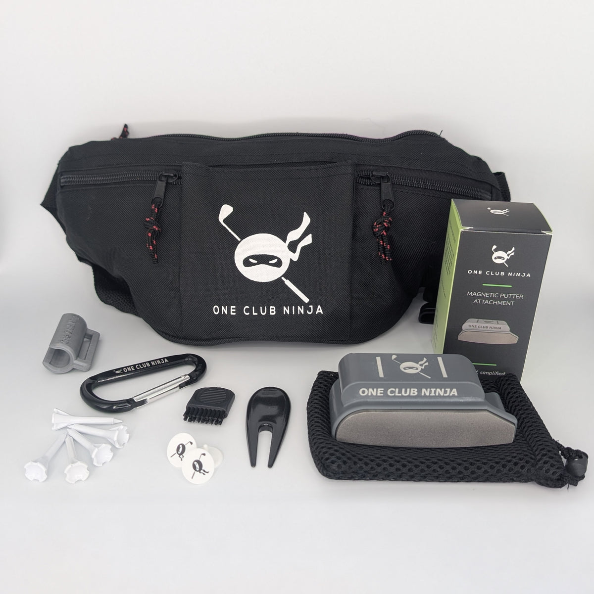 The One Club Kit flat lay with the Obsidian putter attachment, waist bag, and included accessories